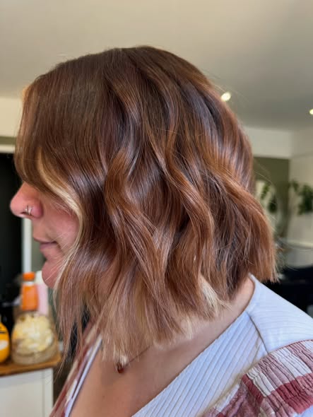 Glossy brunette bob styled in soft waves