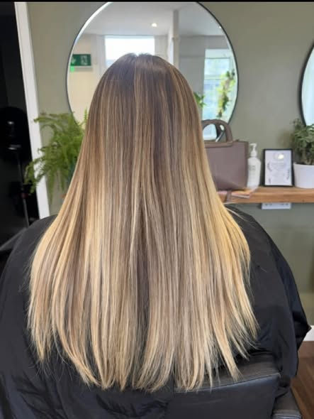 Long straight blonde hair with a glossy salon finish